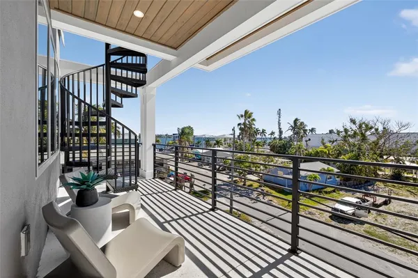 a view of a balcony with wooden benches