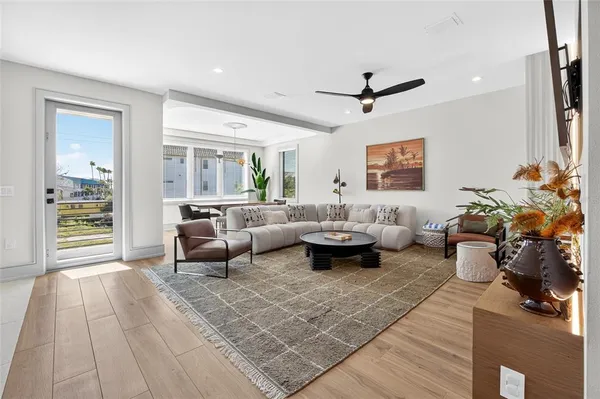 a living room with furniture and wooden floor