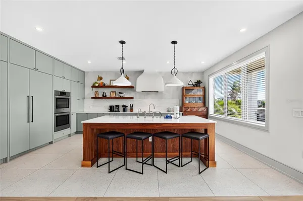 a view of a kitchen with a table and chairs
