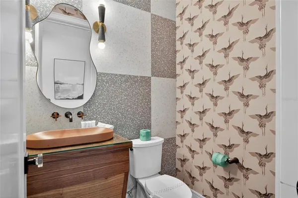 a bathroom with a sink mirror and toilet
