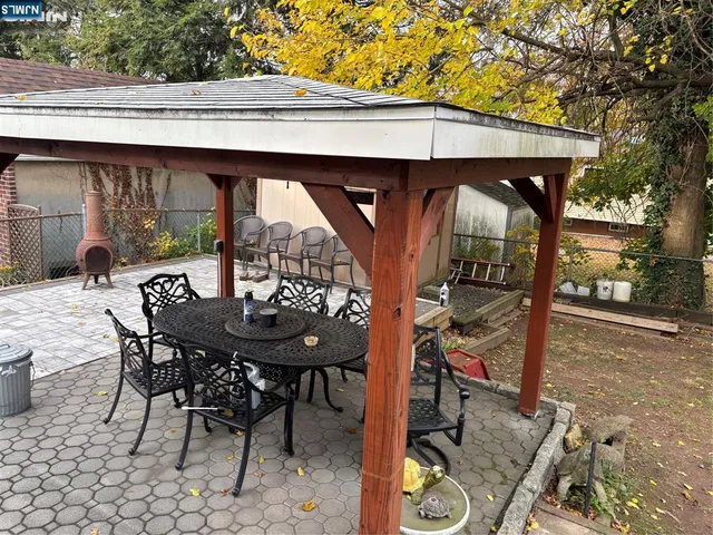 a view of two chairs in the patio