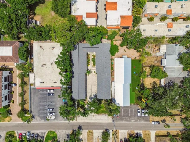 an aerial view of a house with a yard and garden