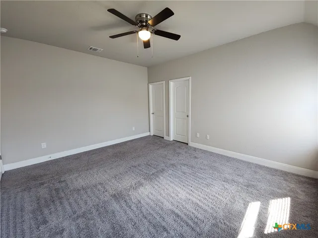 an empty room with a empty space and a ceiling fan