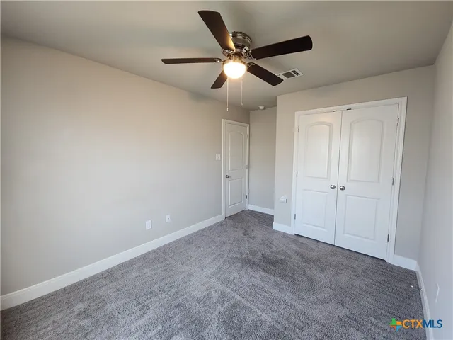 an empty room with closet area