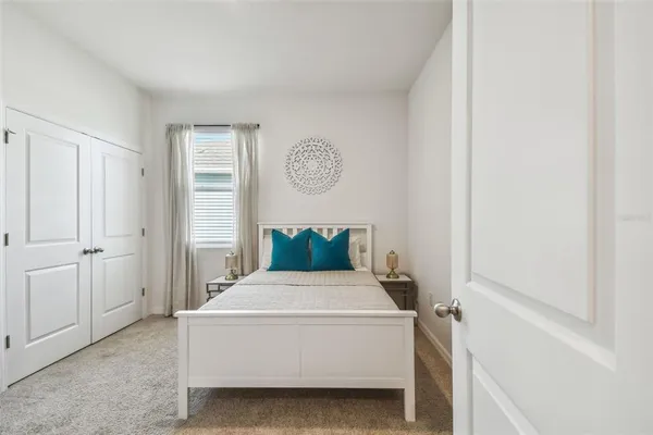 a bedroom with a bed and a window