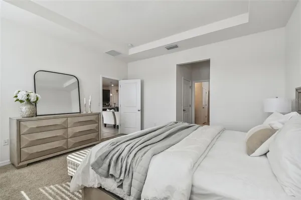 a bedroom with a bed and a dresser