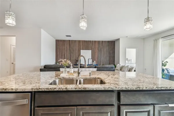 a kitchen with granite countertop kitchen island white cabinets and stainless steel appliances