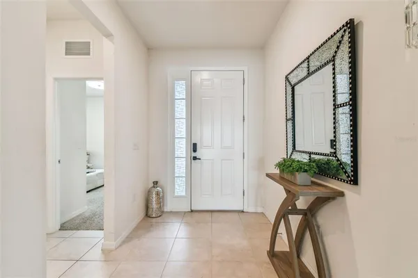 a view of hallway with furniture and a potted plant