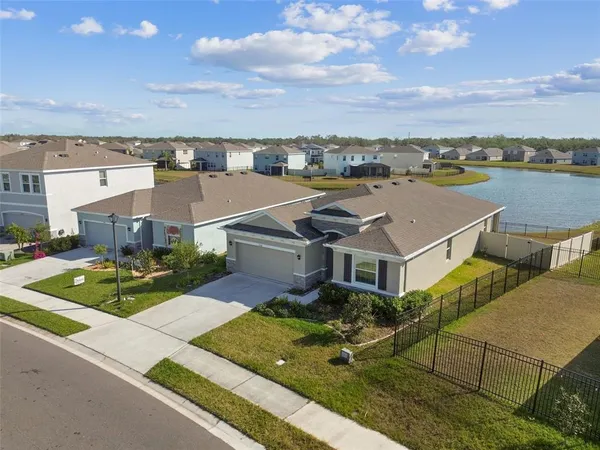 an aerial view of a house with swimming pool and ocean view
