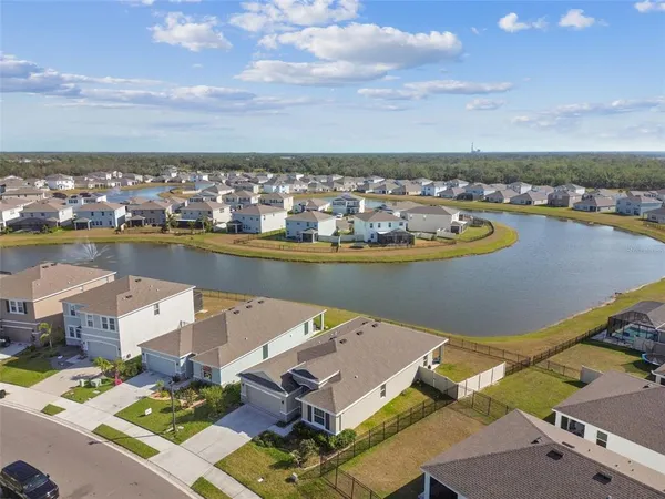 an aerial view of a house with a lake view