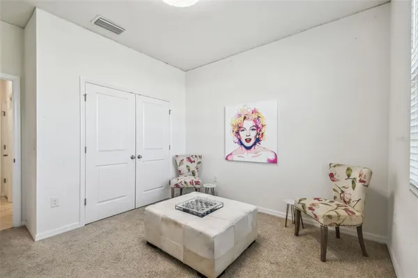 a living room with furniture and a wall painting