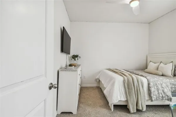 a bedroom with a bed and a flat screen tv