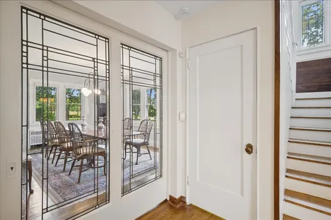 a living room with furniture a fireplace and a large window