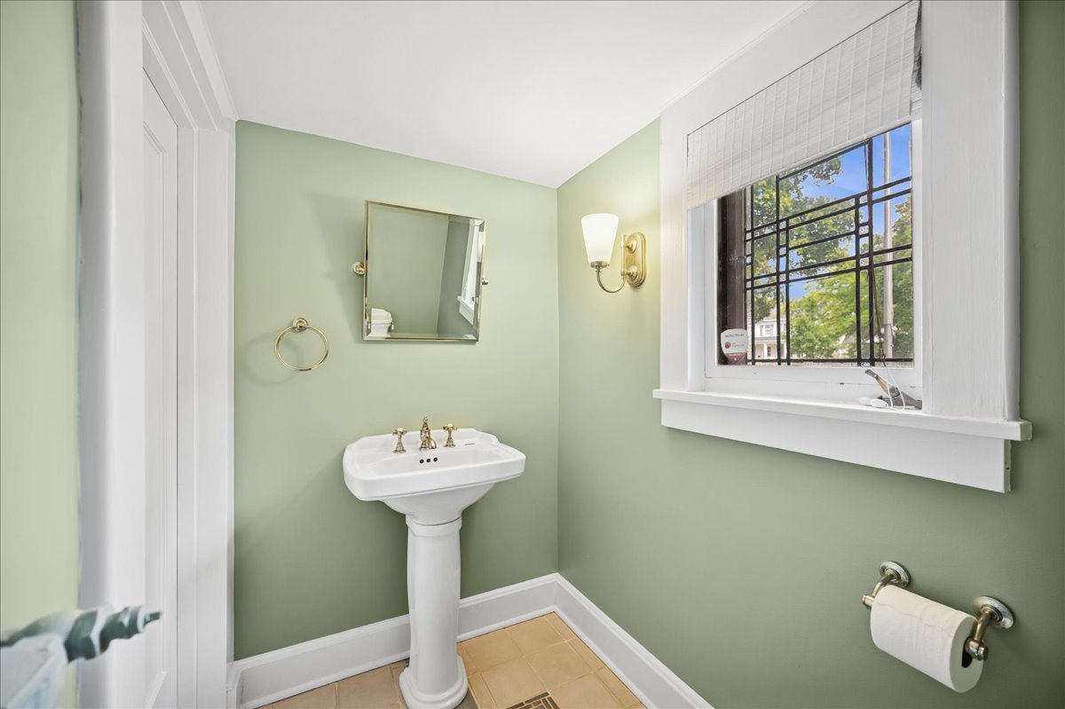 100 Old Green Bay Road Winnetka, IL 60093 - Photo 27 of 60 a bathroom with a sink a mirror and a window