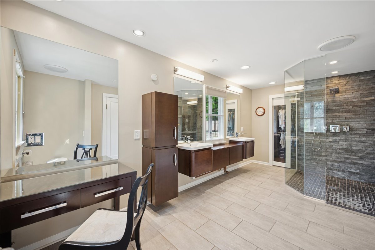 100 Old Green Bay Road Winnetka, IL 60093 - Photo 33 of 60 a bathroom with a double vanity sink a toilet a mirror and shower