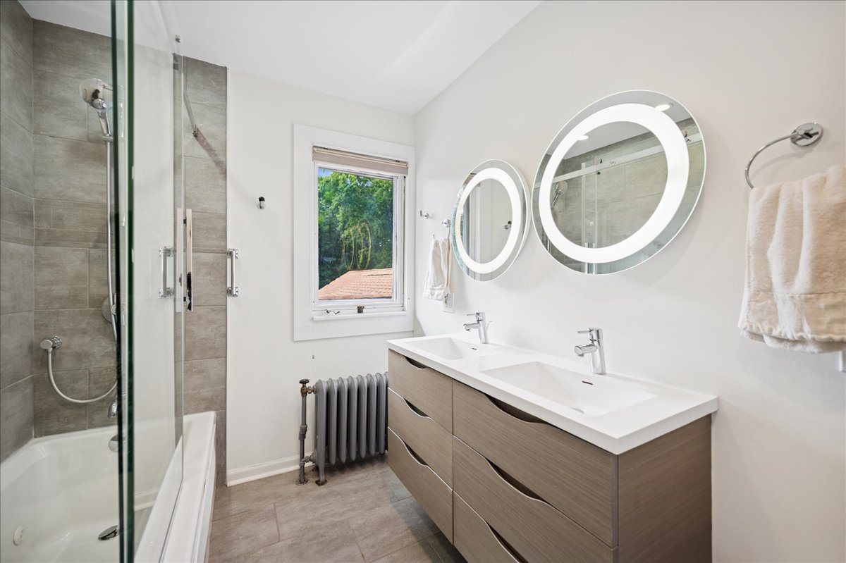 100 Old Green Bay Road Winnetka, IL 60093 - Photo 37 of 60 a bathroom with a sink a mirror a toilet and a shower