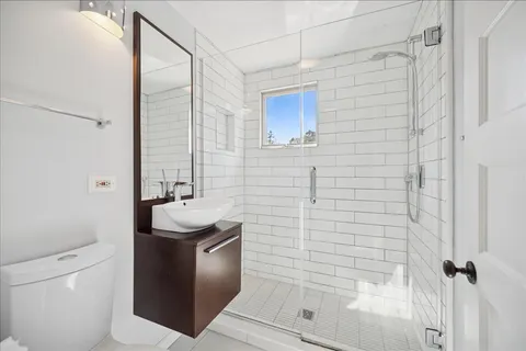a bathroom with a sink toilet and shower