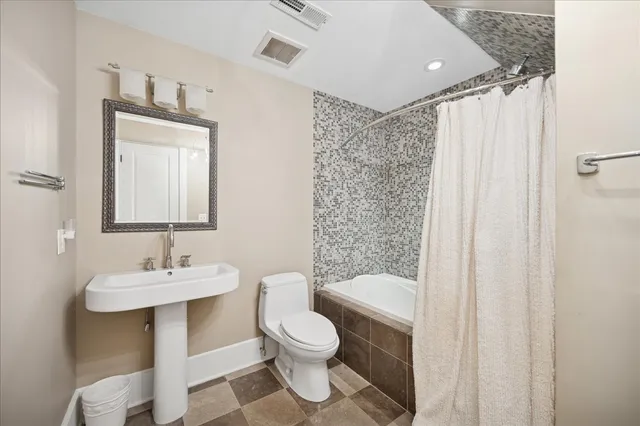 a view of a backyard with table and chairs under an umbrella