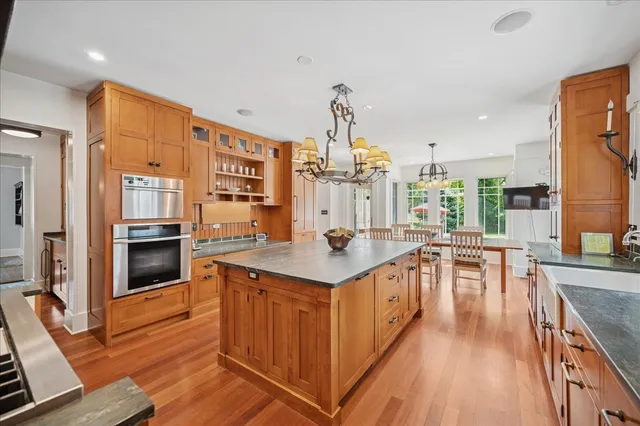 a kitchen with stainless steel appliances granite countertop a stove and cabinets