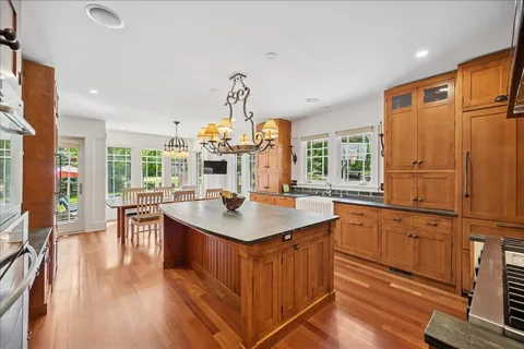 a kitchen with sink cabinets and wooden floor