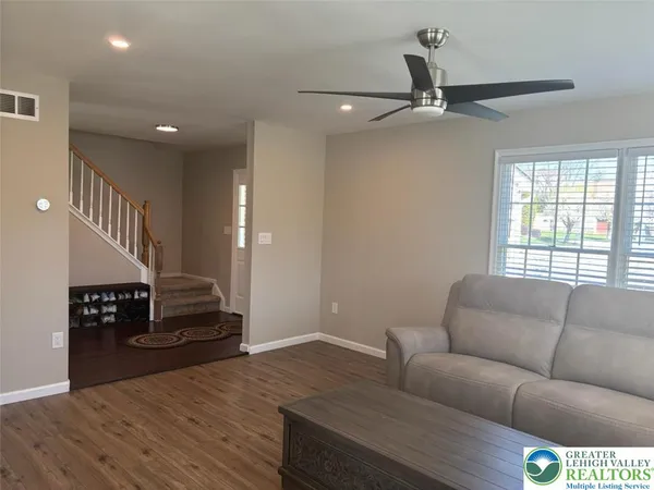 a living room with furniture and a large window