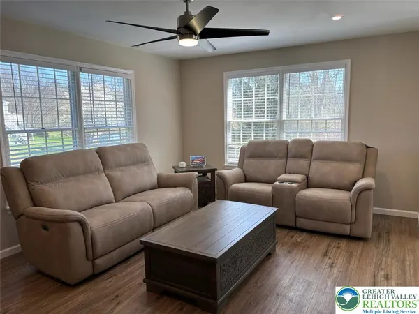 a living room with furniture and a chandelier