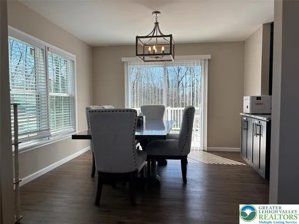 a view of a room with wooden floor and ceiling fan