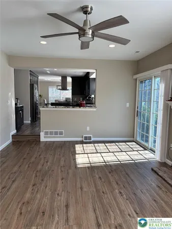 a kitchen with stainless steel appliances granite countertop a refrigerator and a stove