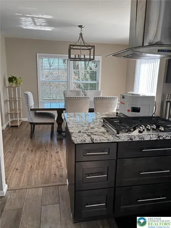a kitchen with stainless steel appliances granite countertop a refrigerator and a stove top oven