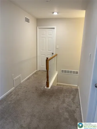 a bedroom with a bed a dresser and flat screen tv