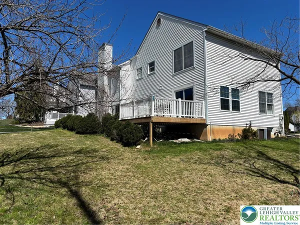 a view of a backyard with large trees