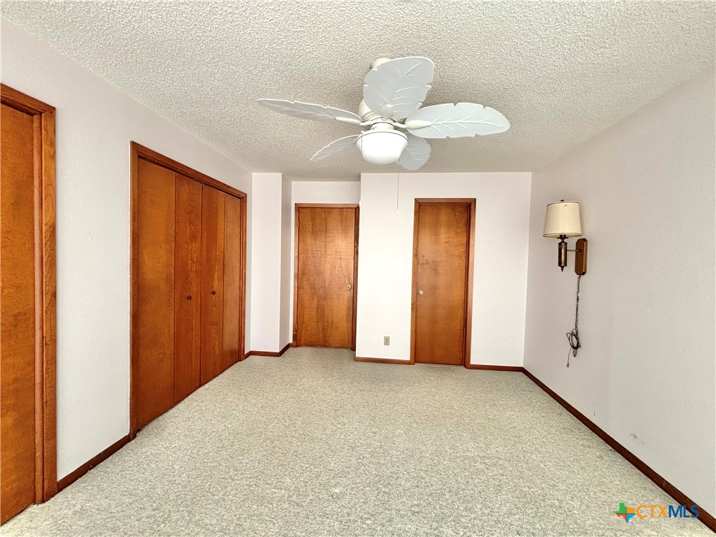 440 15th Street Port O'Connor, TX 77982 - Photo 21 of 40 a view of an empty room with a chandelier fan