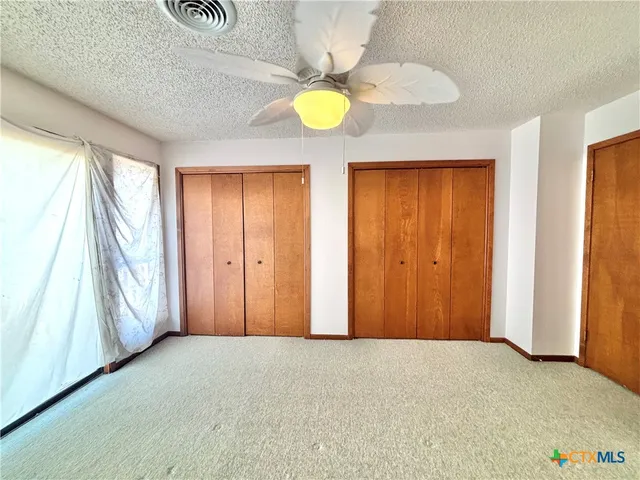 a white toilet sitting next to a shower curtain