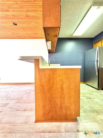 a view of a livingroom with a ceiling fan and window