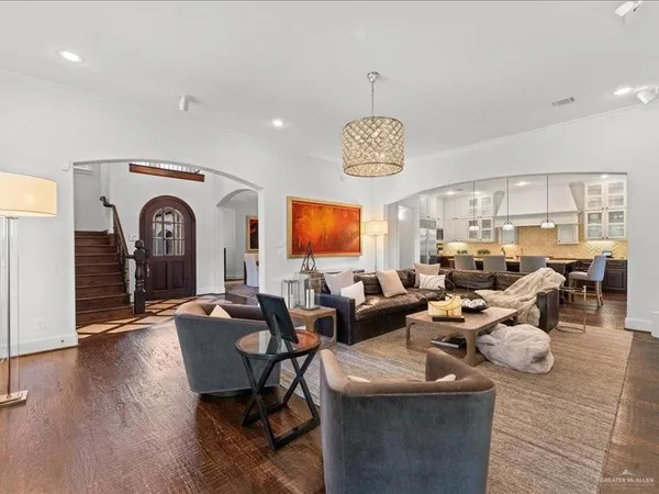 a living room with lots of furniture and a chandelier