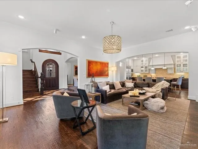 a living room with lots of furniture and a chandelier