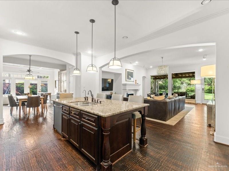 7 Ivy Castle Court Spring, TX 77382 - Photo 45 of 45 a room with stainless steel appliances granite countertop a stove a sink dishwasher and a dining table with the living room view