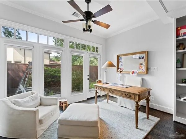 a living room with furniture a flat screen tv and a large window