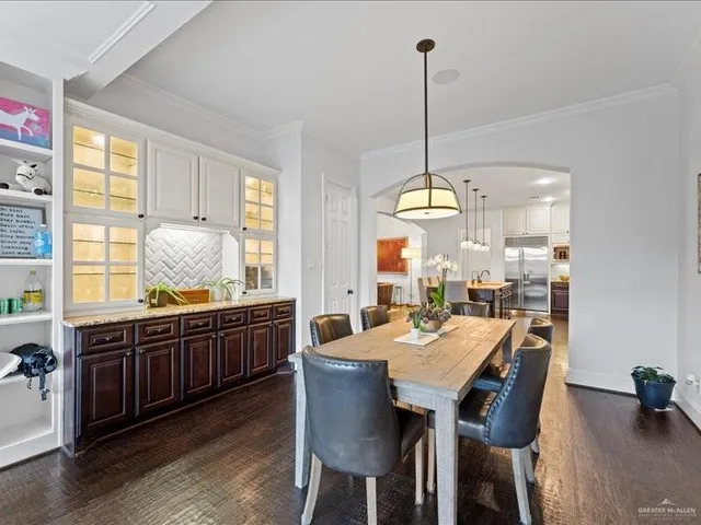 a large kitchen with a table and chairs in it