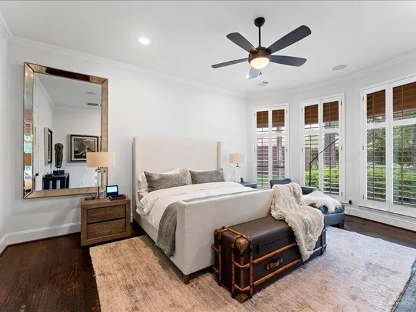 a bedroom with a large bed and a large window