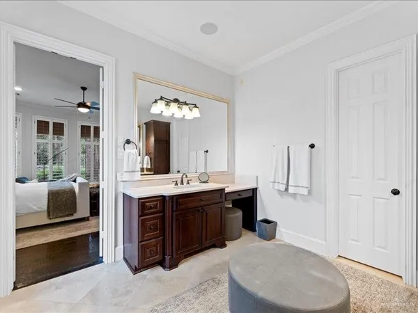 a spacious bathroom with a tub a sink and mirror