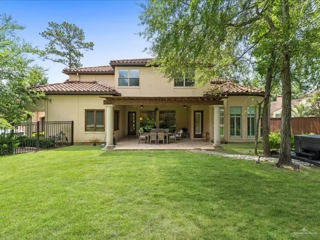 a front view of a house with a garden and patio