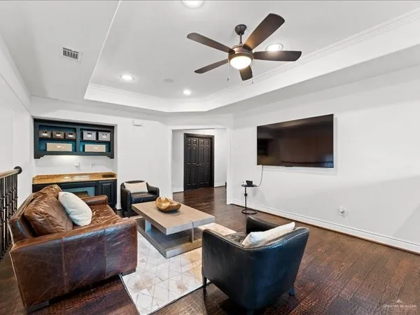 a living room with couches and a flat screen tv