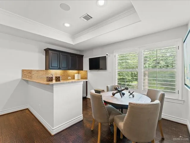 a kitchen with a table chairs and microwave