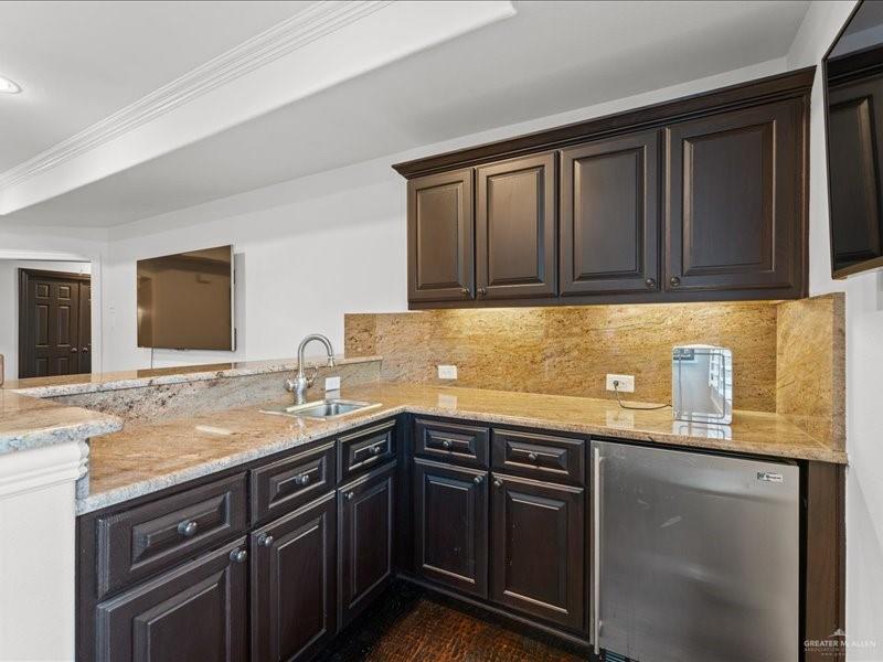 7 Ivy Castle Court Spring, TX 77382 - Photo 35 of 45 a kitchen with granite countertop stainless steel appliances a sink stove and cabinets