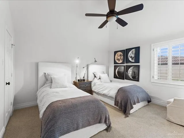 a bathroom with a granite countertop sink a toilet and a mirror