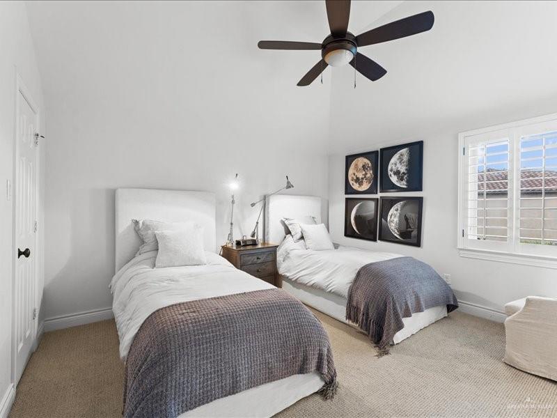 7 Ivy Castle Court Spring, TX 77382 - Photo 42 of 45 a bedroom with two beds and a chandelier