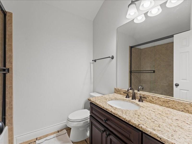 7 Ivy Castle Court Spring, TX 77382 - Photo 43 of 45 a bathroom with a granite countertop sink a toilet and a mirror