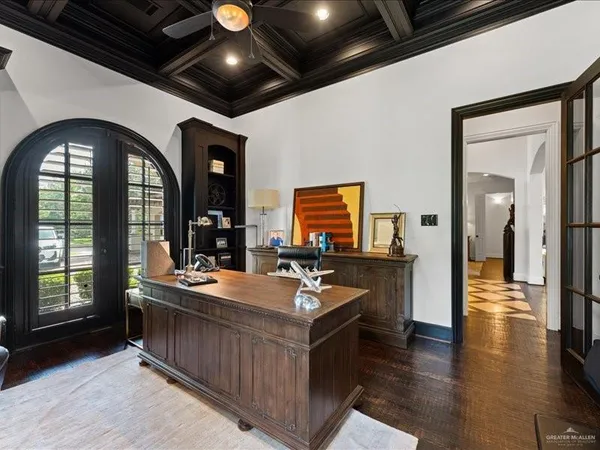 a living room with stainless steel appliances granite countertop furniture and a wooden floors