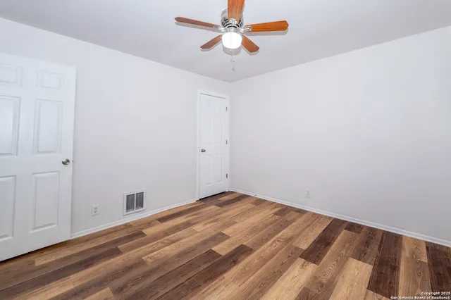 a view of empty room with ceiling fan